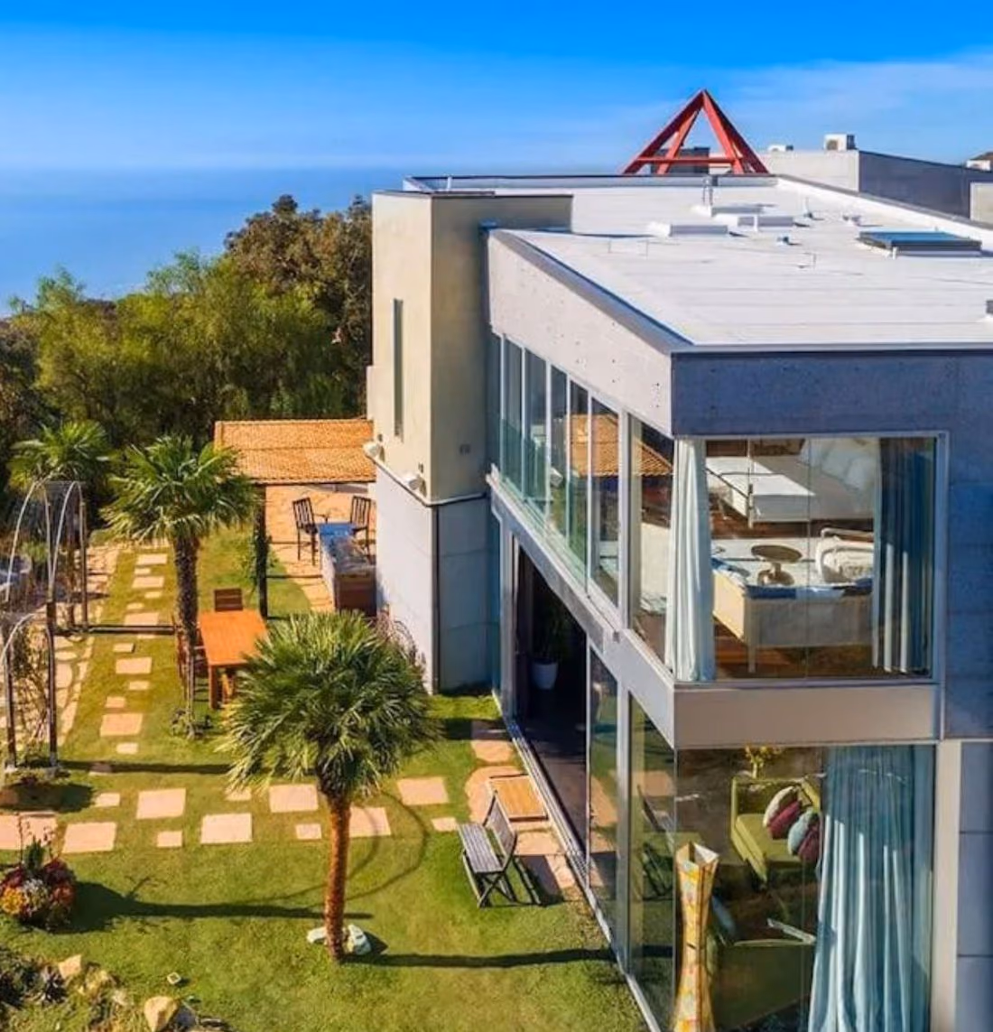 Finished exterior of the renovated Rambla Pacifico home at twilight